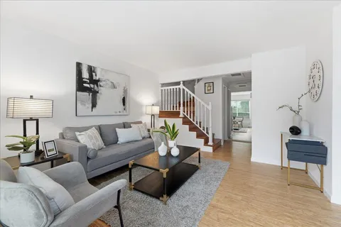 a living room with furniture and a lamp