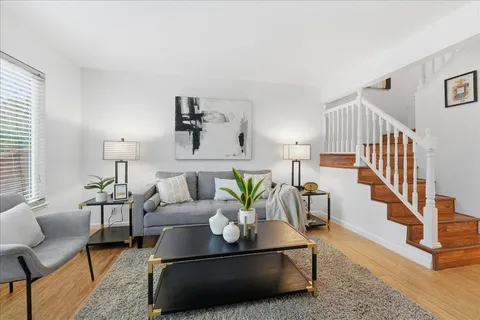a living room with furniture lamp and rug