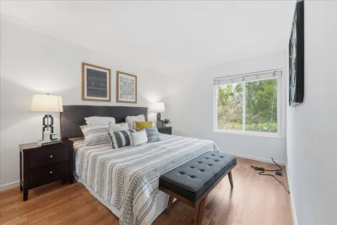 a bedroom with a bed and a tv