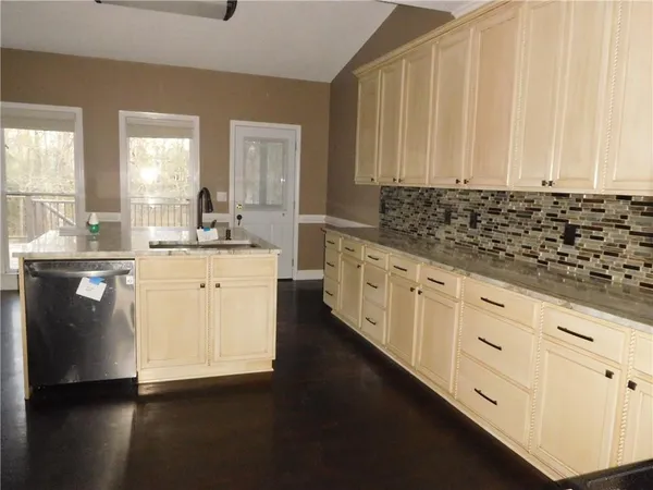 a kitchen with stainless steel appliances a sink and cabinets