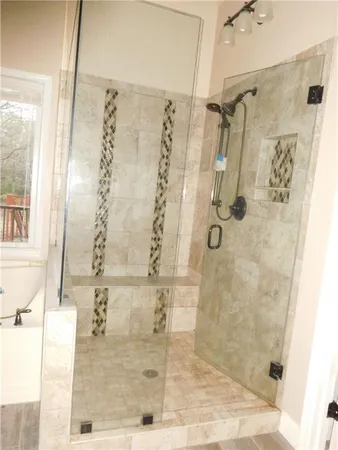 an empty room with a fan and a window