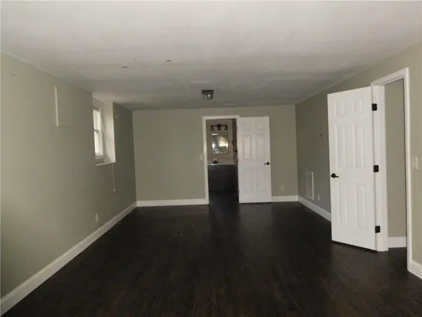 a view of an empty room with a white building