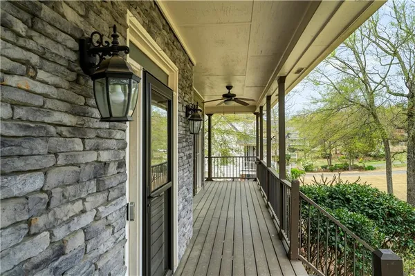 a view of balcony with floor to ceiling windows and wooden floor