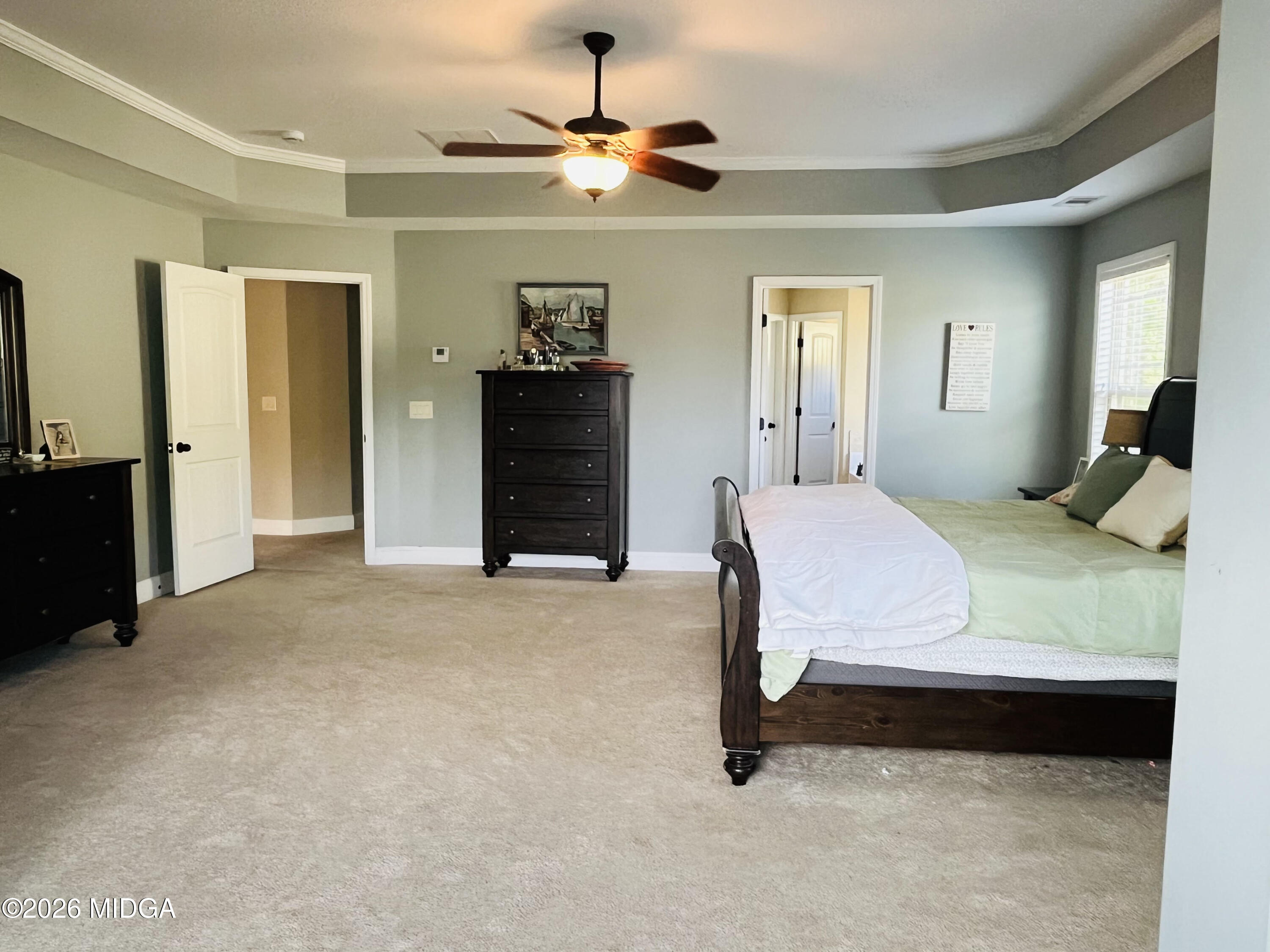 121 Presidents Way Forsyth, GA 31029 - Photo 15 of 25 a bedroom with a bed and a chandelier