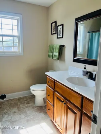 a bathroom with a sink toilet and mirror