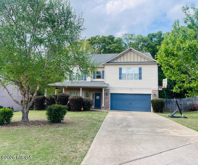 121 Presidents Way Forsyth, GA 31029 - Photo 2 of 25 a front view of a house with a yard and garage