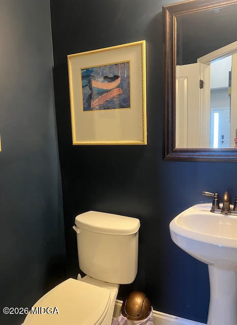 121 Presidents Way Forsyth, GA 31029 - Photo 21 of 25 a bathroom with a toilet a sink and mirror