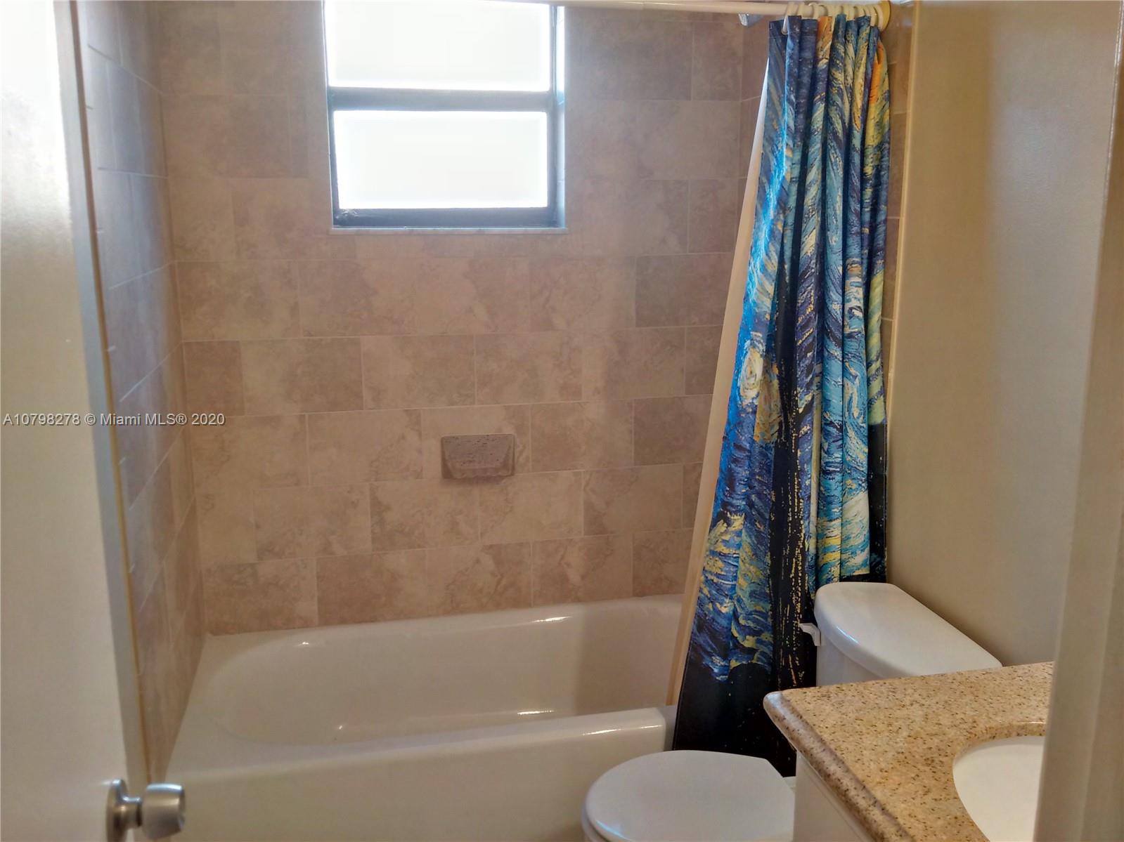 13060 Southwest 263rd Terrace Homestead, FL 33032 - Photo 12 of 28 a bathroom with a toilet and a bathtub