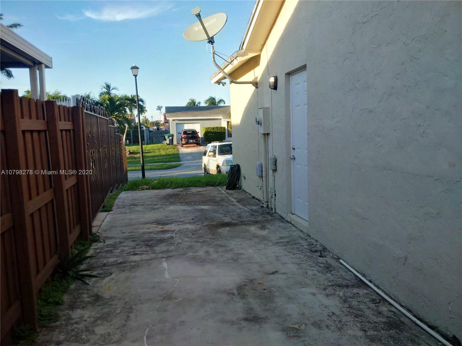 13060 Southwest 263rd Terrace Homestead, FL 33032 - Photo 20 of 28 a view of a backyard with wooden fence