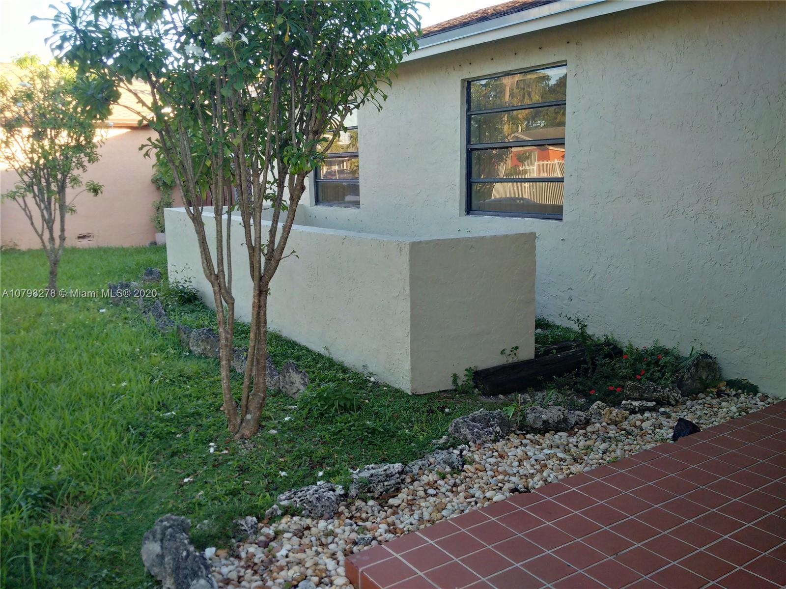 13060 Southwest 263rd Terrace Homestead, FL 33032 - Photo 27 of 28 a front view of a house with garden