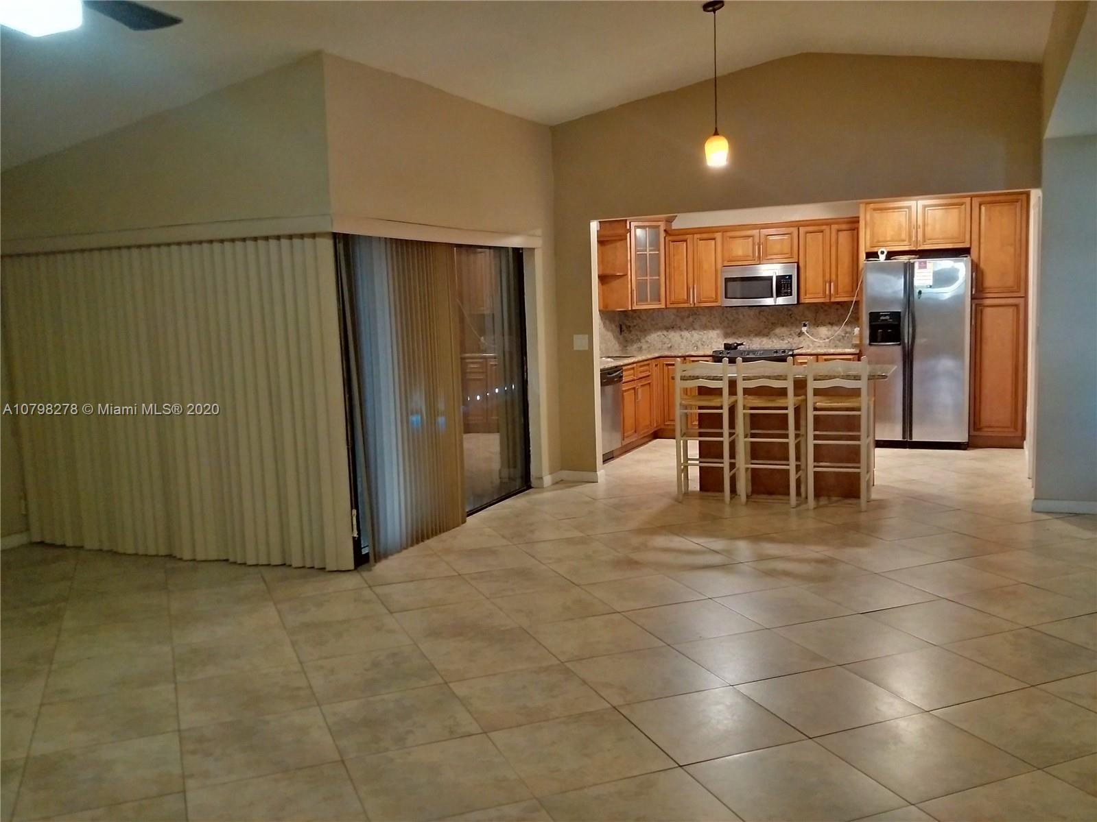 13060 Southwest 263rd Terrace Homestead, FL 33032 - Photo 5 of 28 a view of a kitchen with furniture and stainless steel appliances