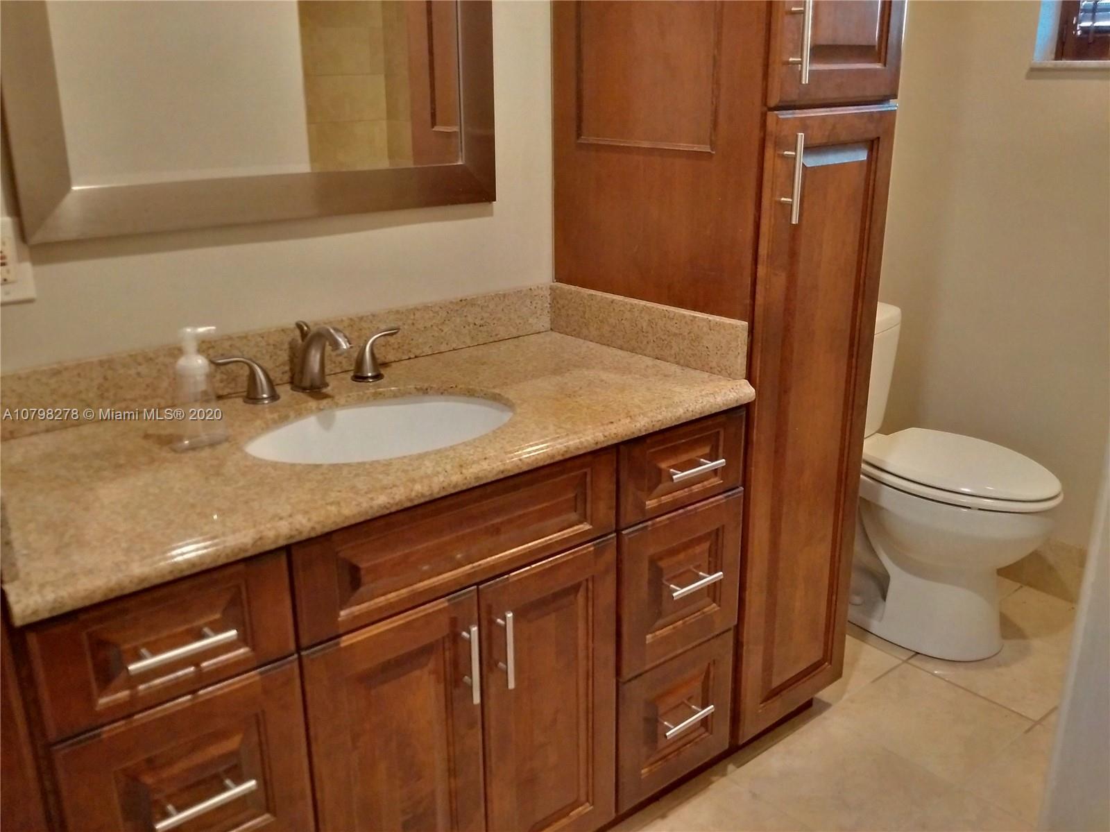 13060 Southwest 263rd Terrace Homestead, FL 33032 - Photo 8 of 28 a bathroom with a granite countertop sink and a toilet