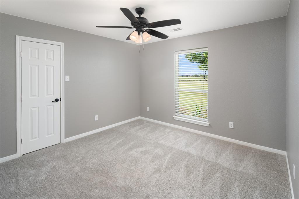 1019 Vaughan Lane Tioga, TX 76271 - Photo 21 of 40 Neutral gray walls complement light-toned carpeting