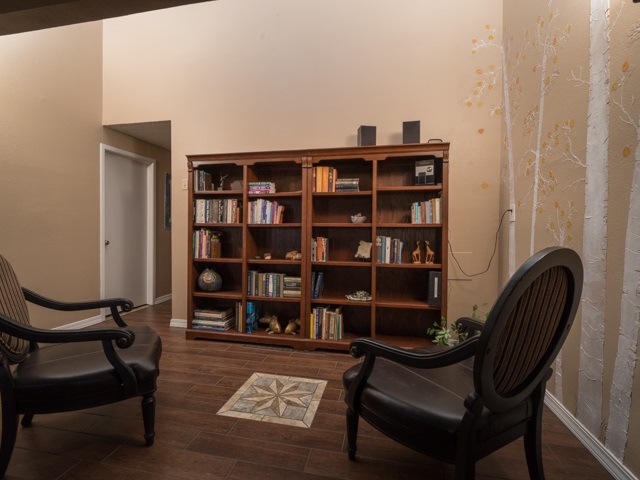 2074 K Road Fruita, CO 81521 - Photo 20 of 28 a view of a workspace with furniture and a book shelf
