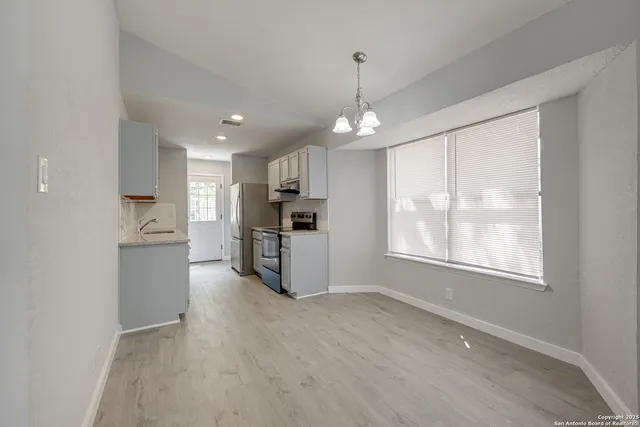 a view of a kitchen with a sink and dishwasher a refrigerator