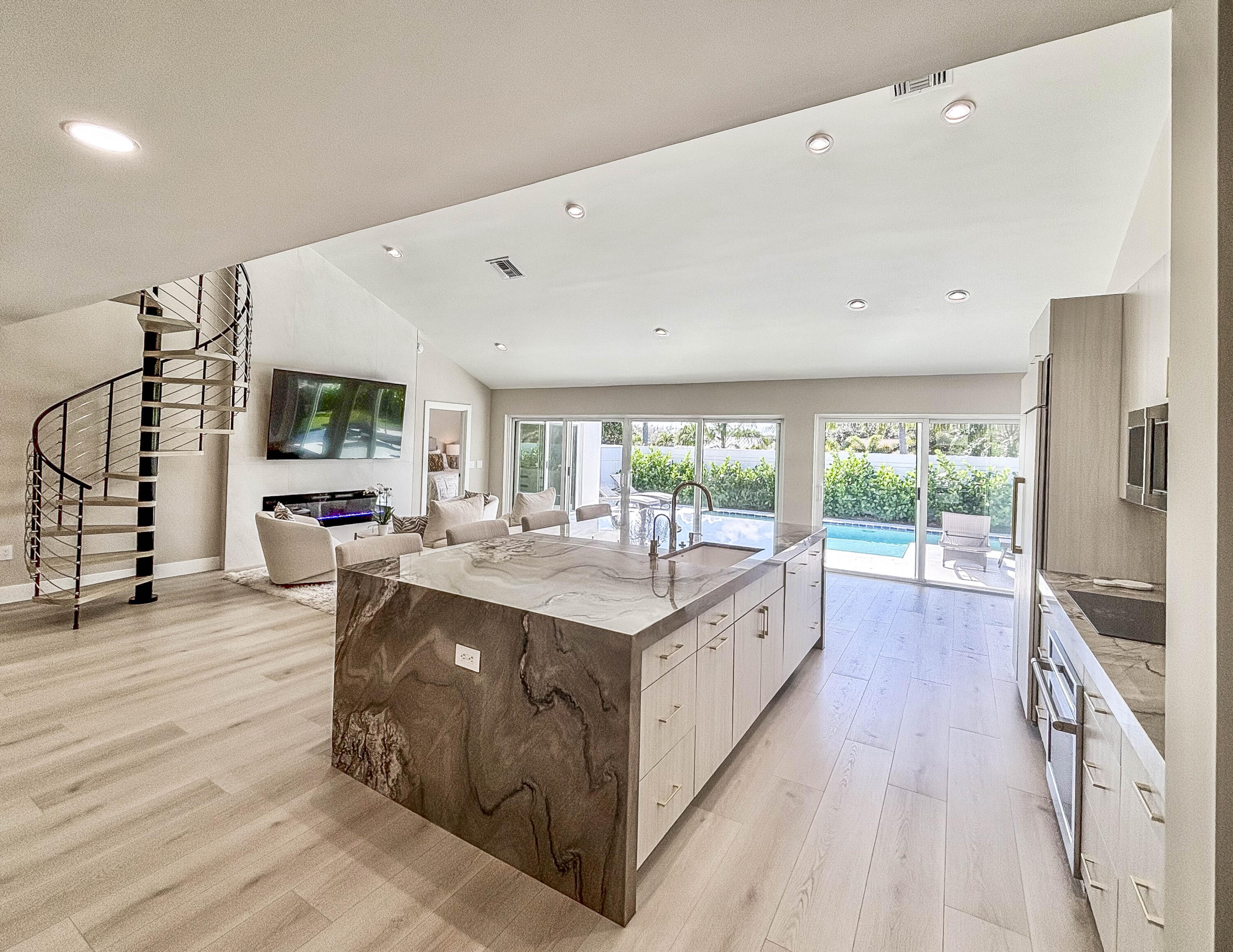 228 Ridge Road Jupiter, FL 33477 - Photo 4 of 13 a large white kitchen with a large window