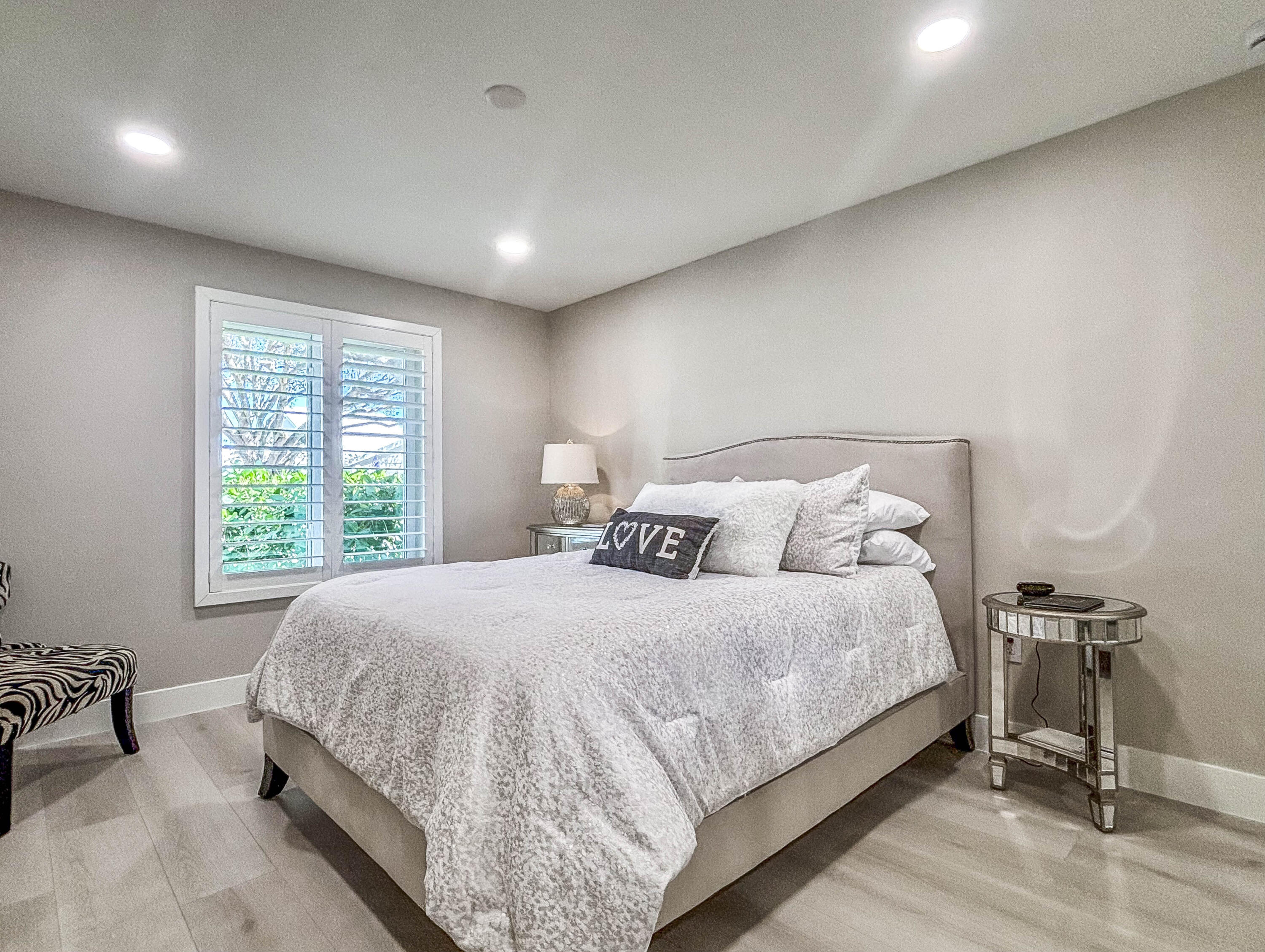 228 Ridge Road Jupiter, FL 33477 - Photo 9 of 13 a bedroom with a bed and a table