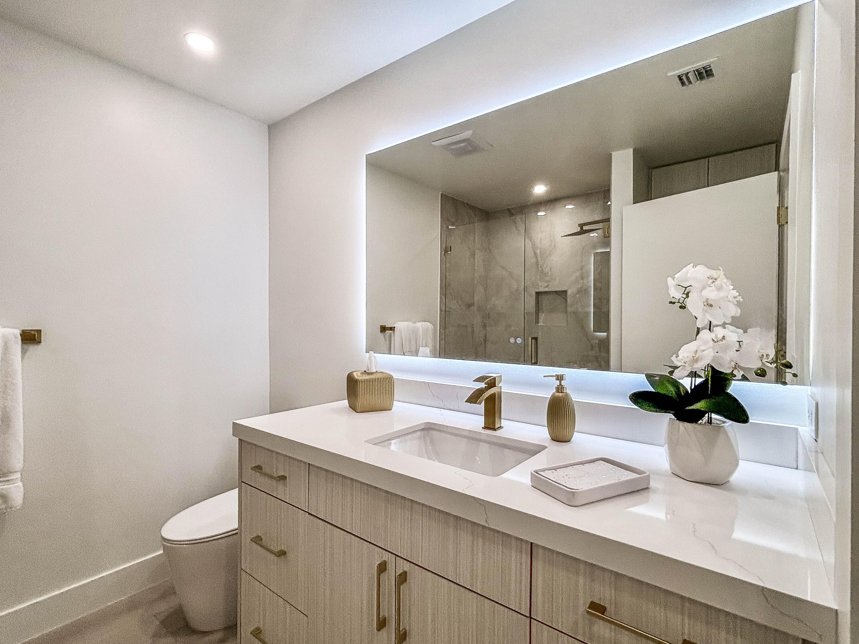 228 Ridge Road Jupiter, FL 33477 - Photo 10 of 13 a bathroom with a toilet sink and mirror