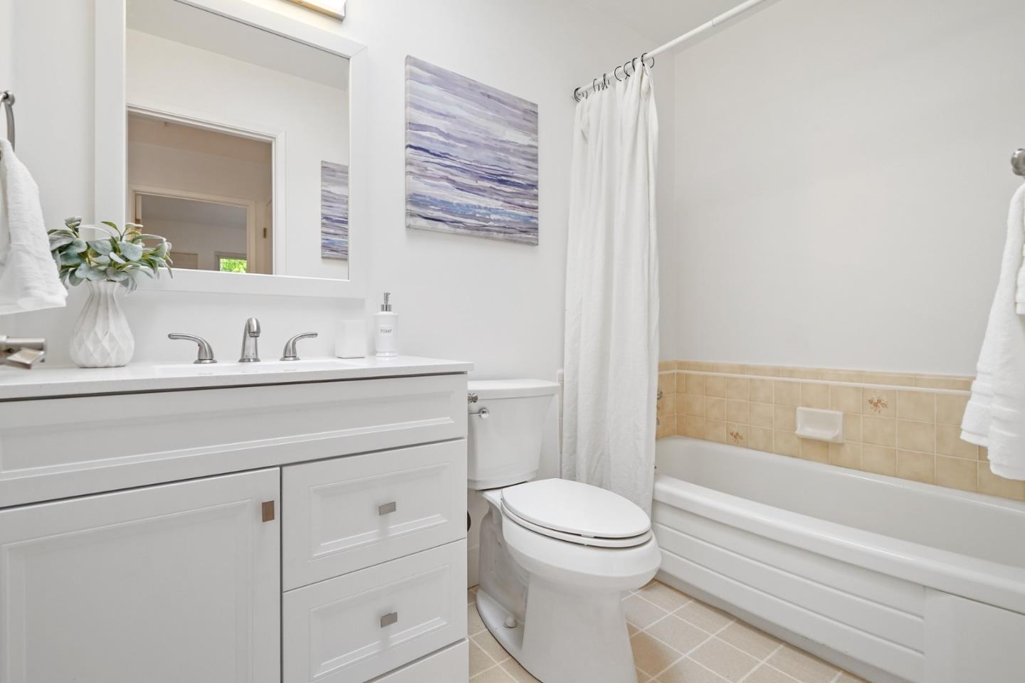 831 Flin Way Sunnyvale, CA 94087 - Photo 23 of 55 a bathroom with a sink a mirror a toilet and bathtub