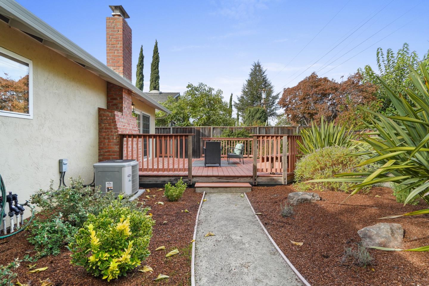 831 Flin Way Sunnyvale, CA 94087 - Photo 35 of 55 a view of a house with wooden fence next to a yard