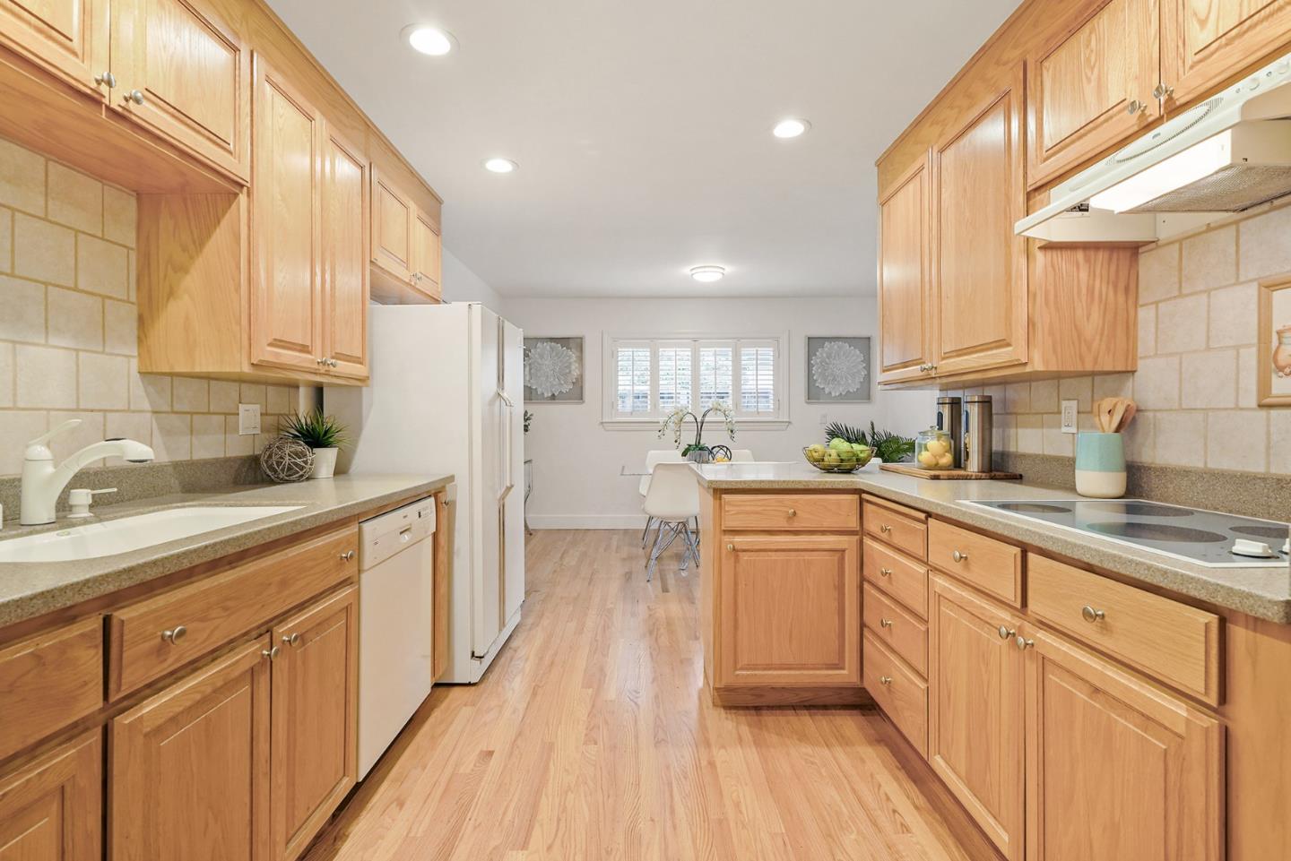 831 Flin Way Sunnyvale, CA 94087 - Photo 6 of 55 a kitchen with granite countertop white cabinets and white appliances