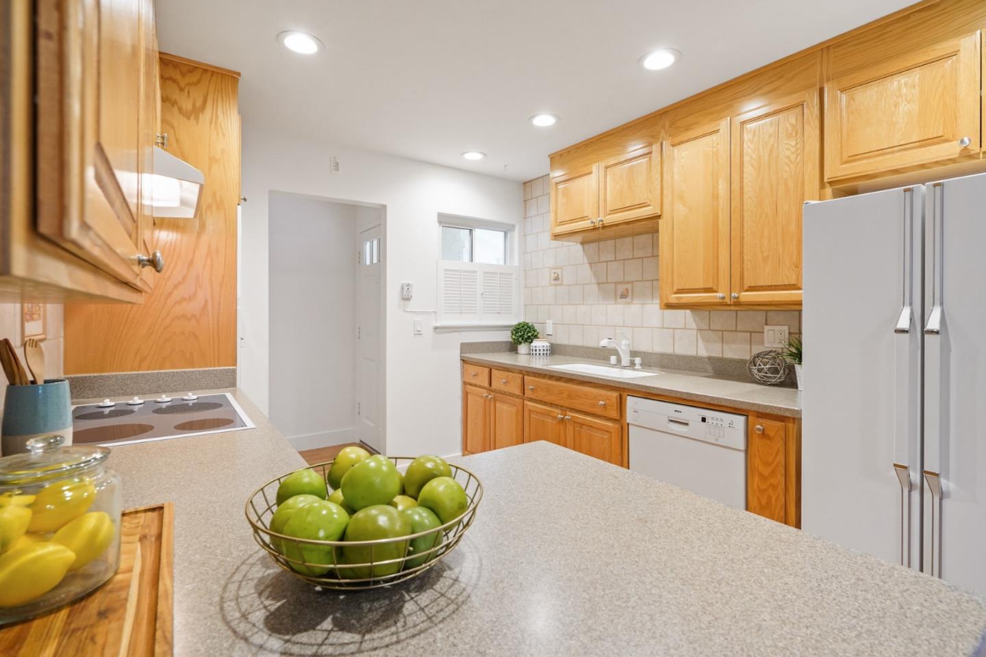 831 Flin Way Sunnyvale, CA 94087 - Photo 7 of 55 a kitchen with stainless steel appliances granite countertop a sink and a refrigerator
