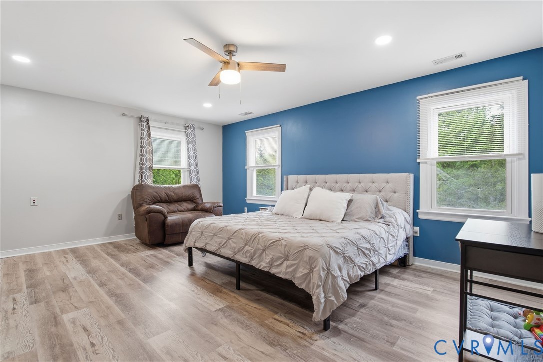9110 Gayton Road Henrico, VA 23229 - Photo 22 of 54 a spacious bedroom with a bed a couch and a window
