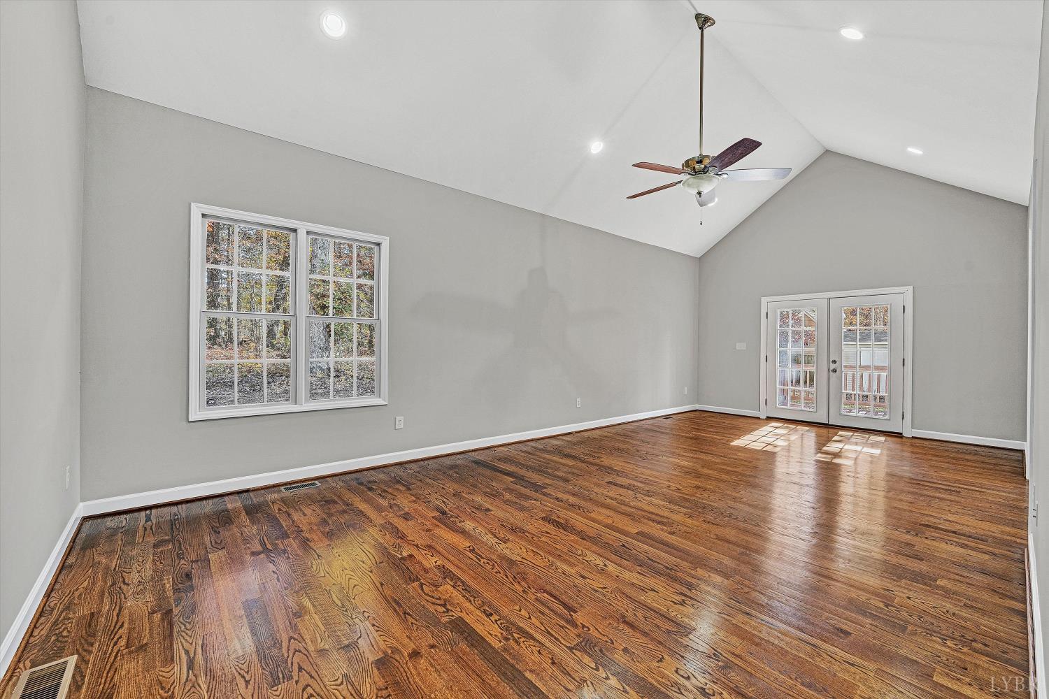 1182 Dan River Church Road South Boston, VA 24592 - Photo 11 of 43 a view of an empty room with wooden floor and a window