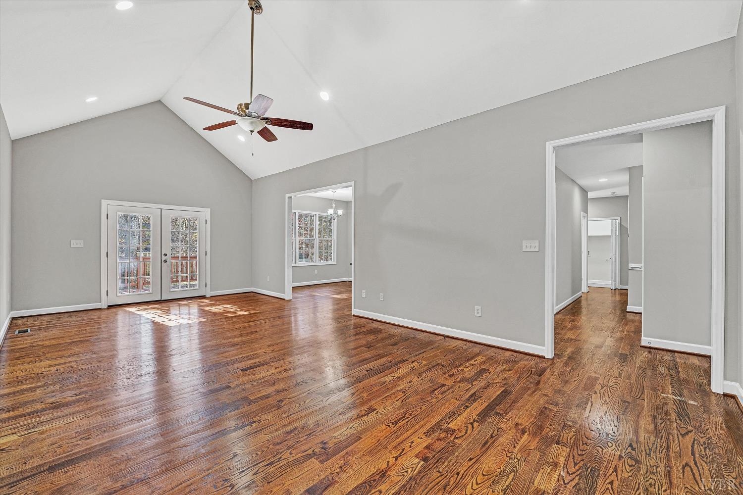 1182 Dan River Church Road South Boston, VA 24592 - Photo 12 of 43 a view of an empty room with wooden floor and a ceiling fan