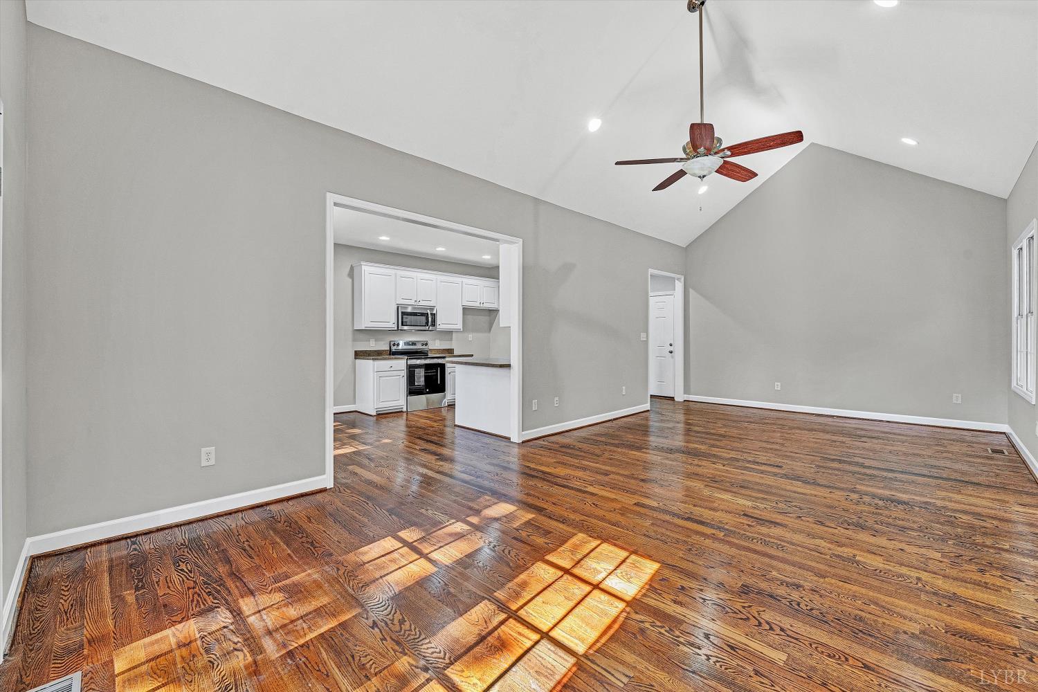 1182 Dan River Church Road South Boston, VA 24592 - Photo 13 of 43 a view of empty room with wooden floor and ceiling fan