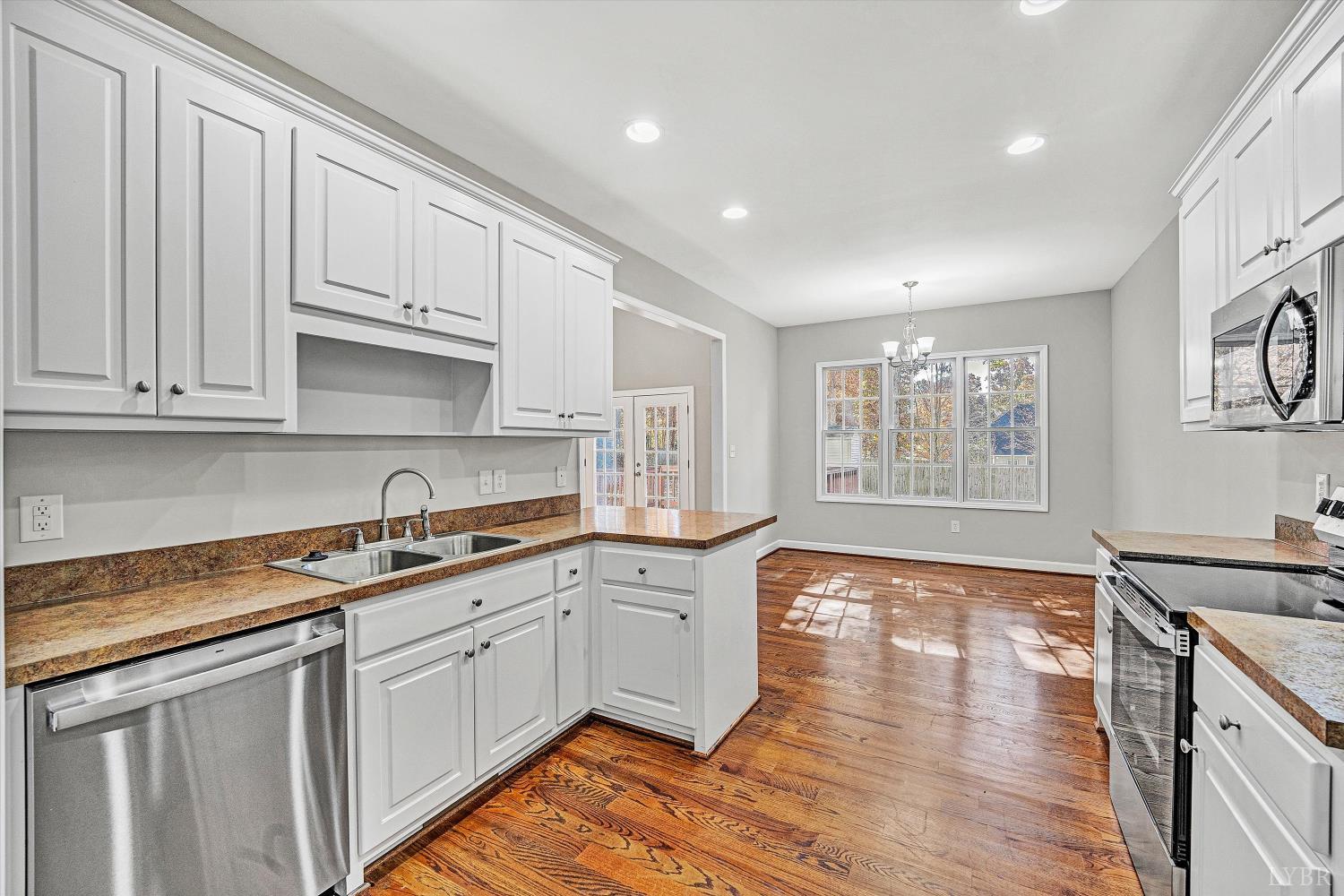 1182 Dan River Church Road South Boston, VA 24592 - Photo 16 of 43 a kitchen with granite countertop white cabinets and white appliances