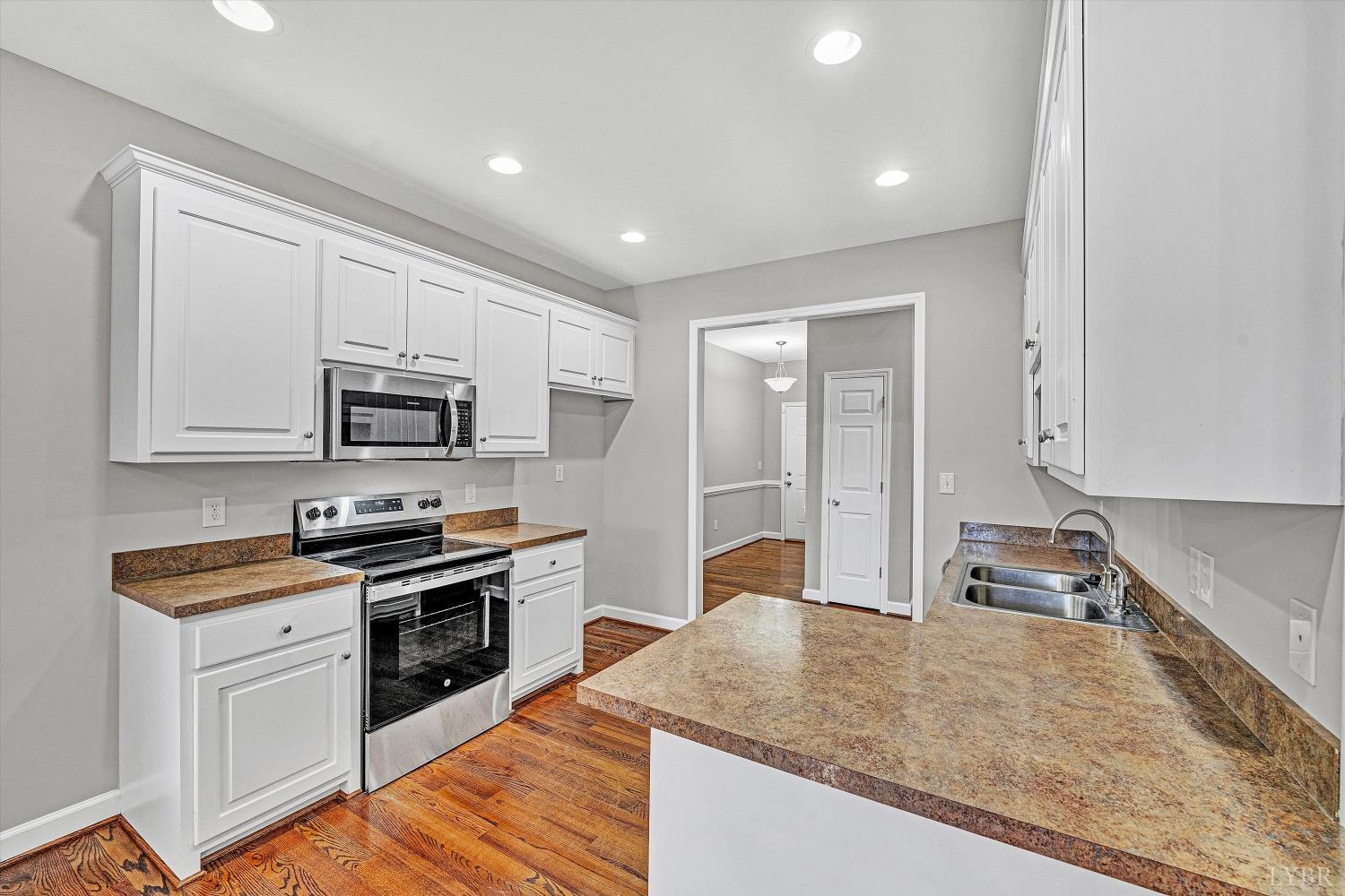 1182 Dan River Church Road South Boston, VA 24592 - Photo 20 of 43 a kitchen with stainless steel appliances granite countertop a sink stove and refrigerator