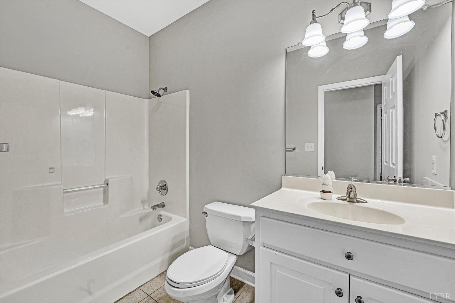 1182 Dan River Church Road South Boston, VA 24592 - Photo 21 of 43 a bathroom with a sink a toilet a mirror a vanity and bathtub