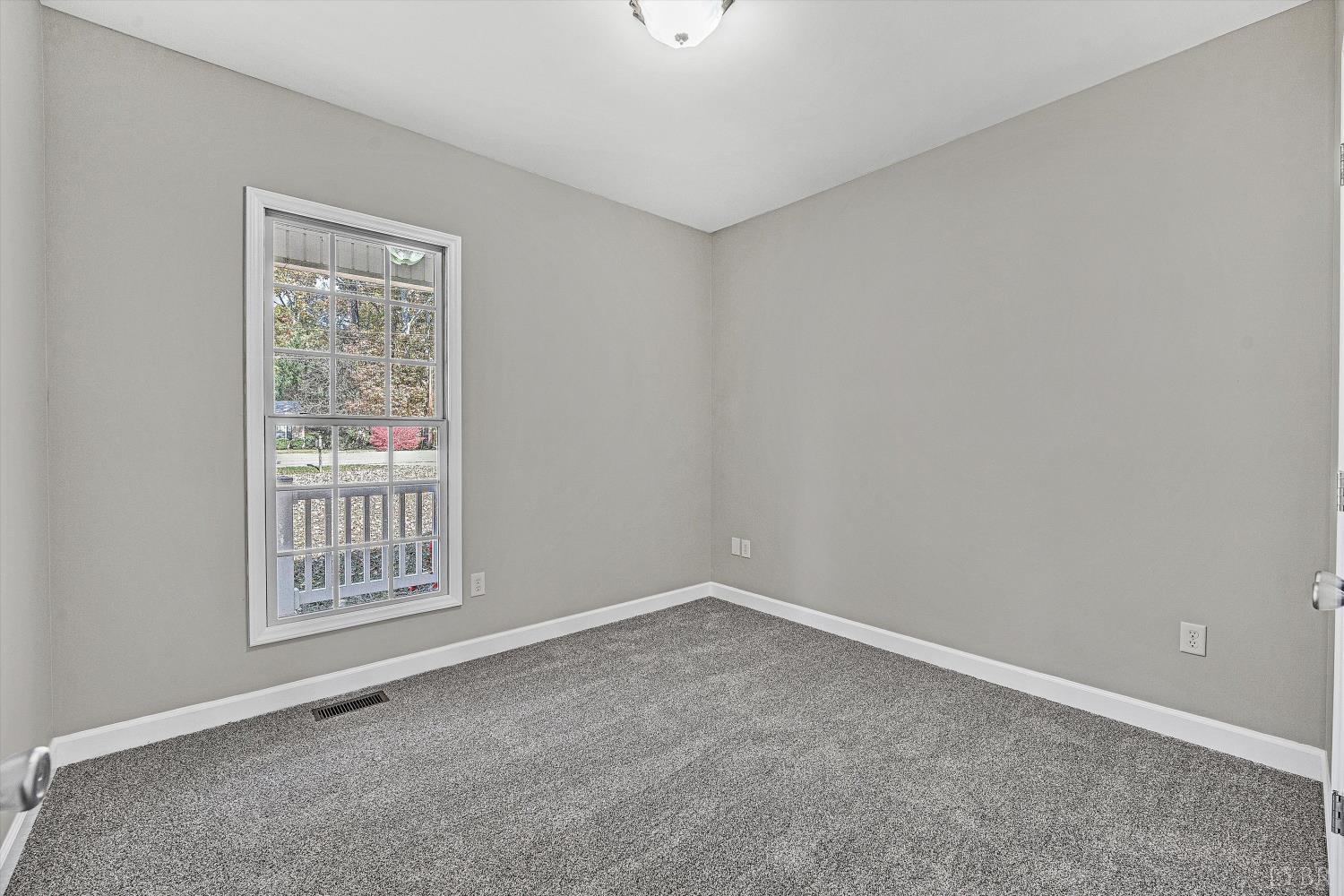 1182 Dan River Church Road South Boston, VA 24592 - Photo 22 of 43 a view of an empty room with a window