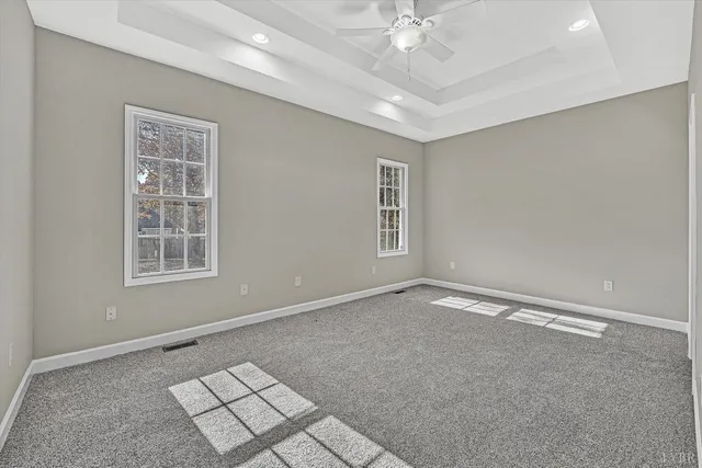 a view of an empty room with a ceiling fan