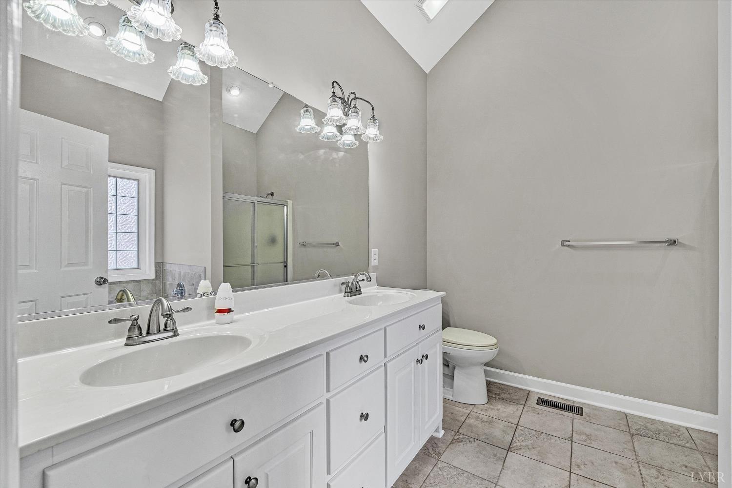 1182 Dan River Church Road South Boston, VA 24592 - Photo 30 of 43 a bathroom with a double vanity sink mirror and toilet