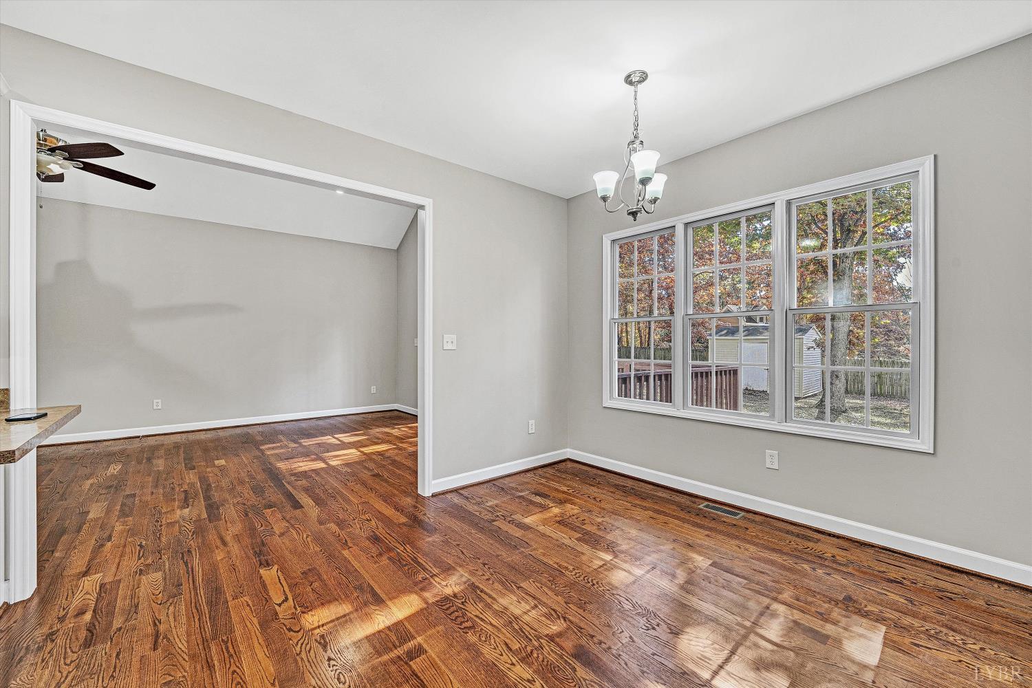 1182 Dan River Church Road South Boston, VA 24592 - Photo 34 of 43 a view of an empty room with a window and wooden floor