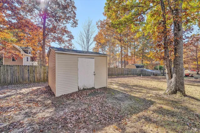 a view of a house with a yard and sitting area