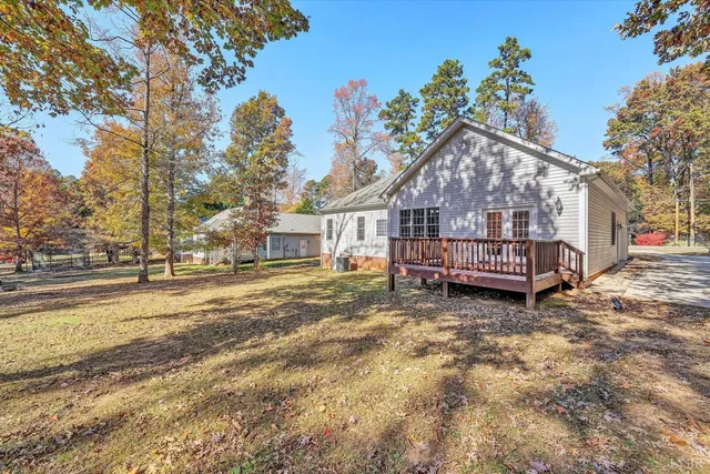 a front view of a house with a yard covered with snow