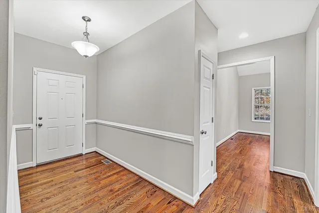 a view of a room with wooden floor and staircase