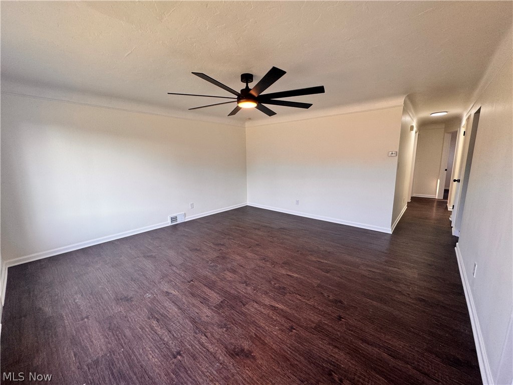 2907 Snow Road, Unit UP Cleveland, OH 44134 - Photo 6 of 19 Unfurnished room with dark wood-type flooring, ceiling fan, and a textured ceiling