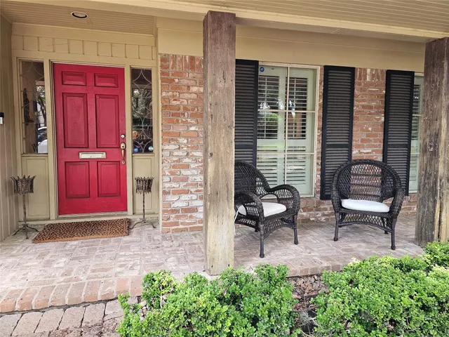 a view of front door of house with outdoor seating