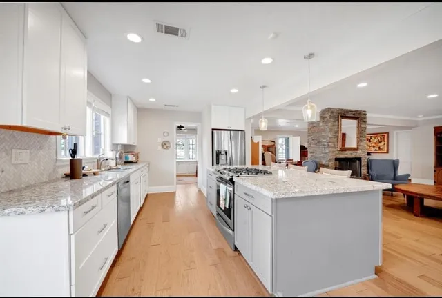 a large kitchen with stainless steel appliances lots of counter top space