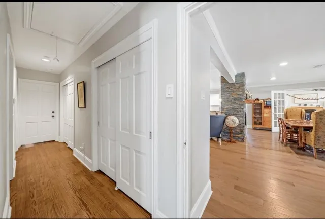 a view of a hallway to a livingroom and a livingroom with furniture