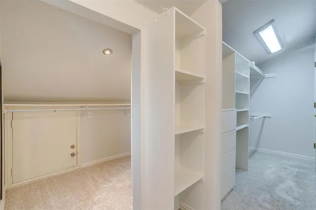 a view of kitchen with granite countertop cabinets and window