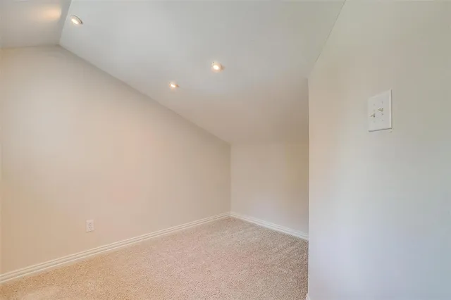 a room with pool table and wooden floor