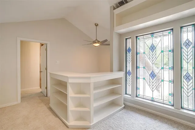 a view of a porch with wooden floor and windows