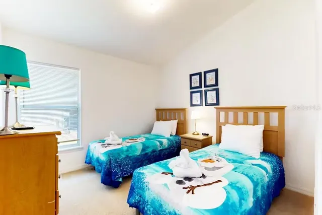 a bed room with two beds and a night stand