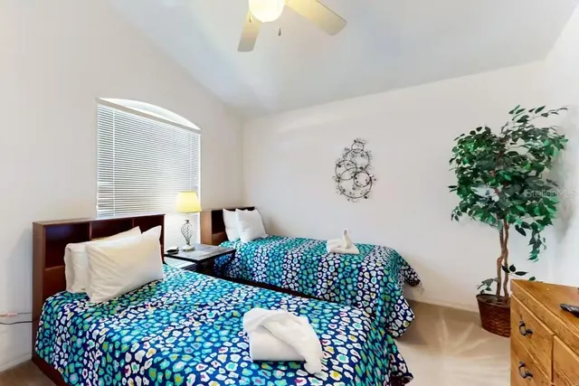 a bedroom with a bed and a potted plant