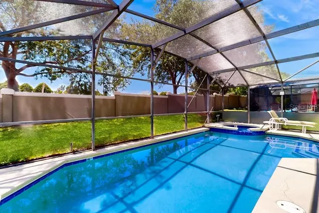 a view of swimming pool with a patio and a yard